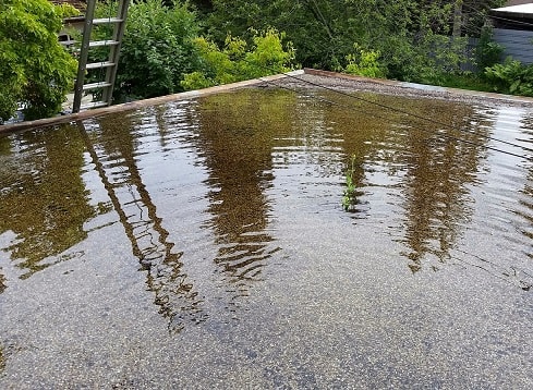 Water almost collapsed this tar and gravel flat roof on a garage in Edmonton, Alberta-min